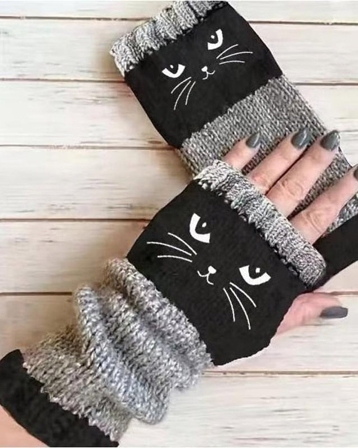 Black knit fingerless gloves with embroidered cat face