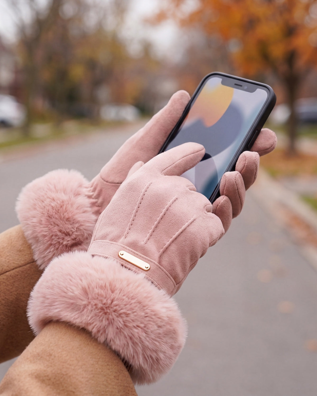Pink faux fur cuff gloves used on a smartphone touchscreen