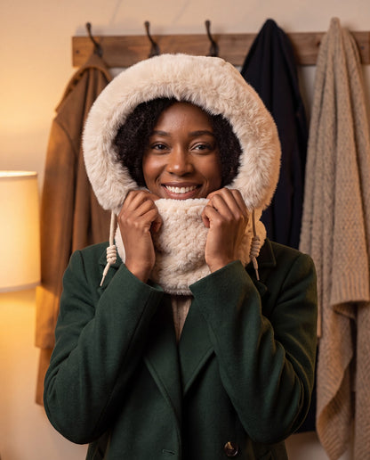 Beige 3-in-1 faux fur hooded scarf worn as a warm hood with the neck warmer