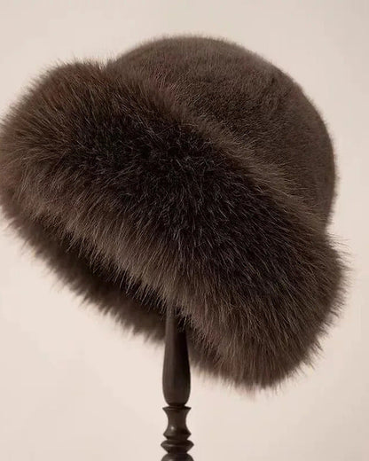 Brown faux fur hat with rolled brim on a hat stand
