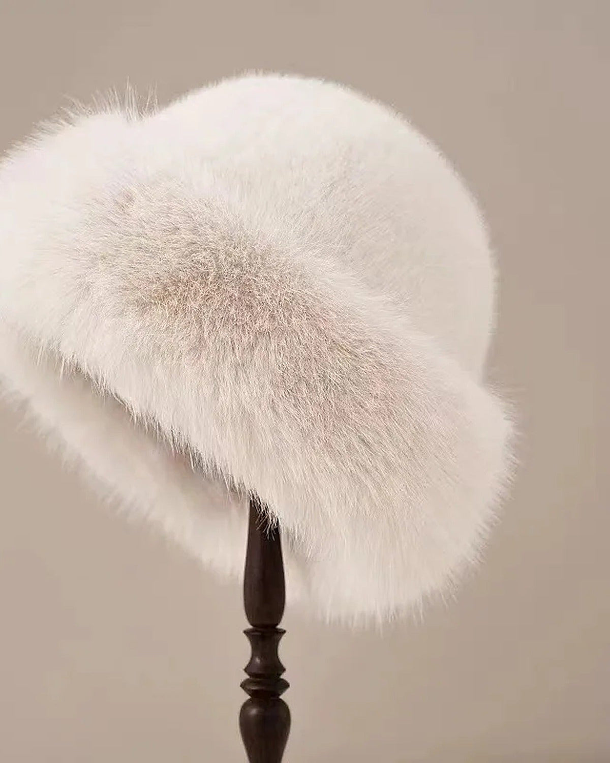 Milky White faux fur hat with rolled brim on a hat stand
