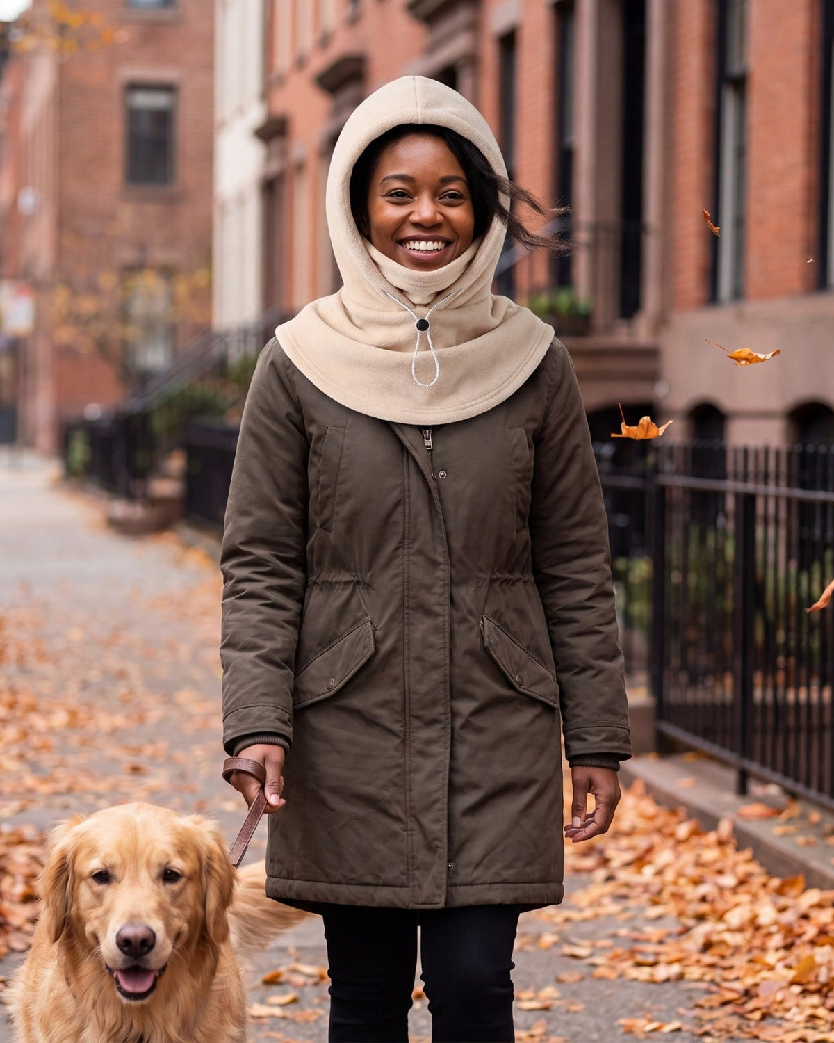 Woman walking her dog in the beige fleece hood with the face panel folded down