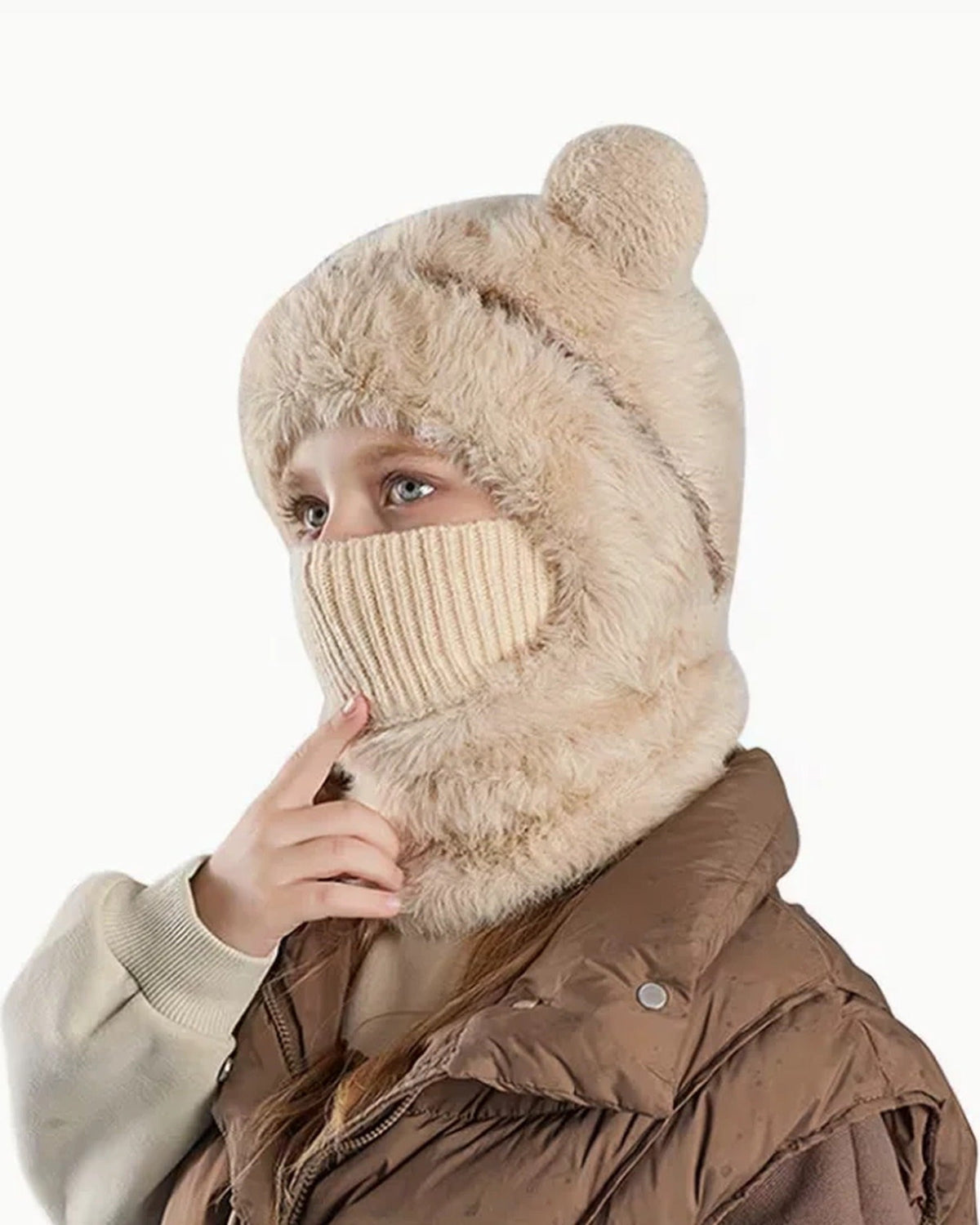 Girl wearing a beige teddy bear hood with the knit face cover pulled up