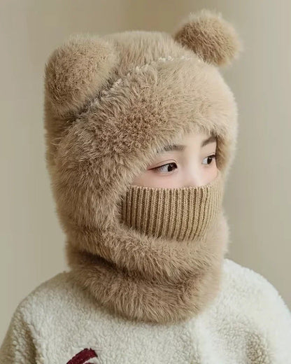 Child wearing a khaki teddy bear hood with the knit face cover pulled up