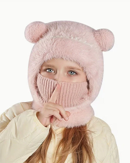 Girl wearing a pink teddy bear hood with the knit face cover pulled up