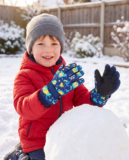 Boy wearing navy printed kids waterproof gloves while playing outdoors